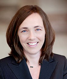 Kristin Norse Kristin Norse headshot, Caucasian businesswoman with brown hair wearing a dark navy suit