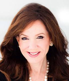 Laurie Silvers Laurie Silvers headshot, Caucasian businesswoman with brown hair is wearing a black blazer and pearl necklace, she's pictured in front of a white backdrop