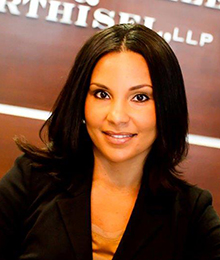 Niva Hiller-Harney Niva Hiller-Harney is a young professional businesswoman wearing a black suit pictured in front of a brown wall