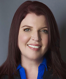 Renee Thompson Renee Thompson headshot, Caucasian woman wearing business attire with a bright blue button down shirt, she has brown hair and is pictured in front of a solid gray backdrop