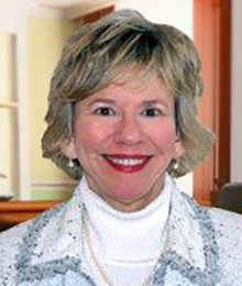 Susan Churuti Susan Churuti headshot, Caucasian woman, smiling and wearing a white turtleneck with a light colored jacket